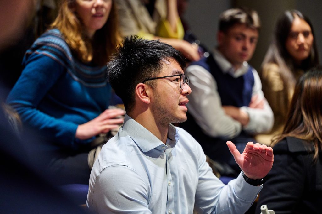 Man in audience asking question at event in the Bradfield Centre auditorium