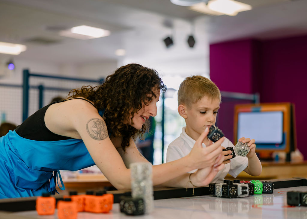 Cambridge Science Centre worker with child